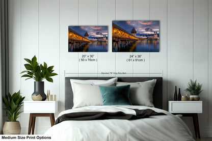 a bedroom with a bed and two pictures on the wall