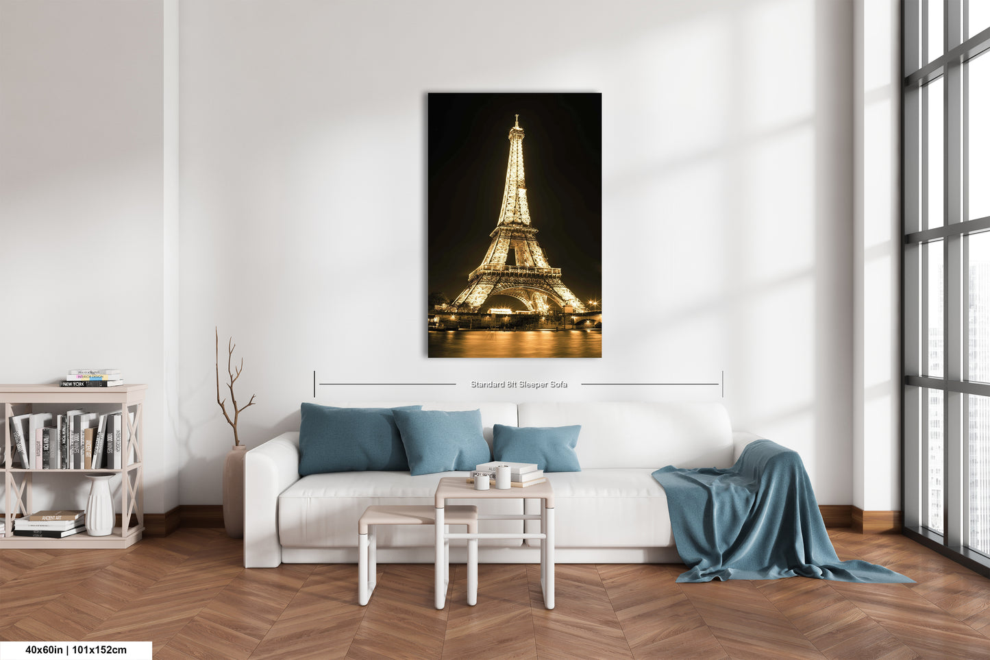 a living room with a white couch and a picture of the eiffel tower