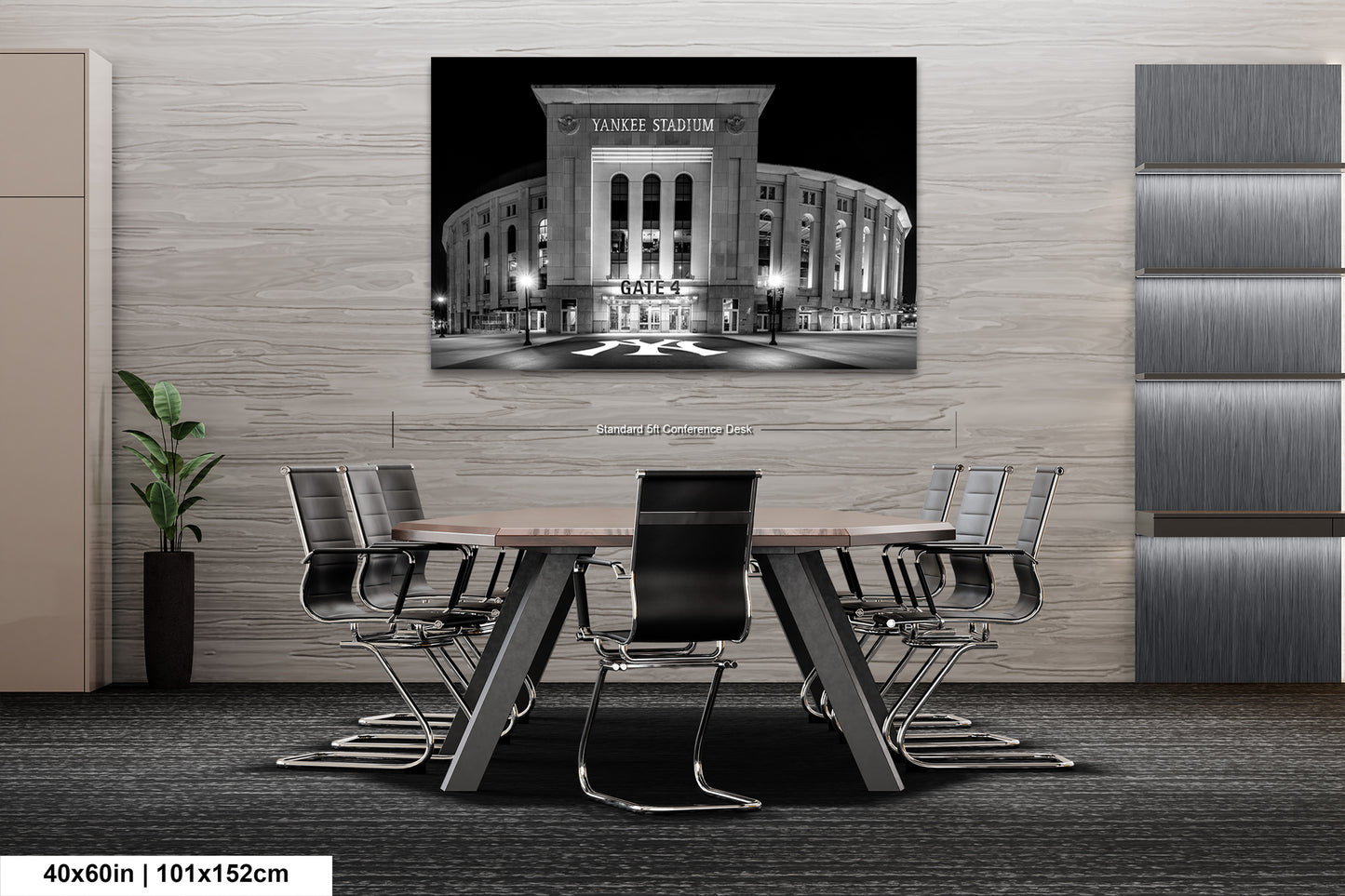 a modern office setting with a large black and white photograph of Yankee Stadium prominently displayed on the wall. The photograph is framed and hangs above a wooden conference table surrounded by chairs.