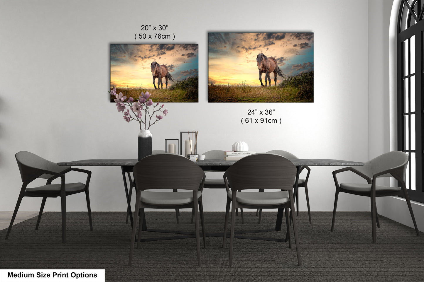 a dining room table with four chairs and two pictures on the wall