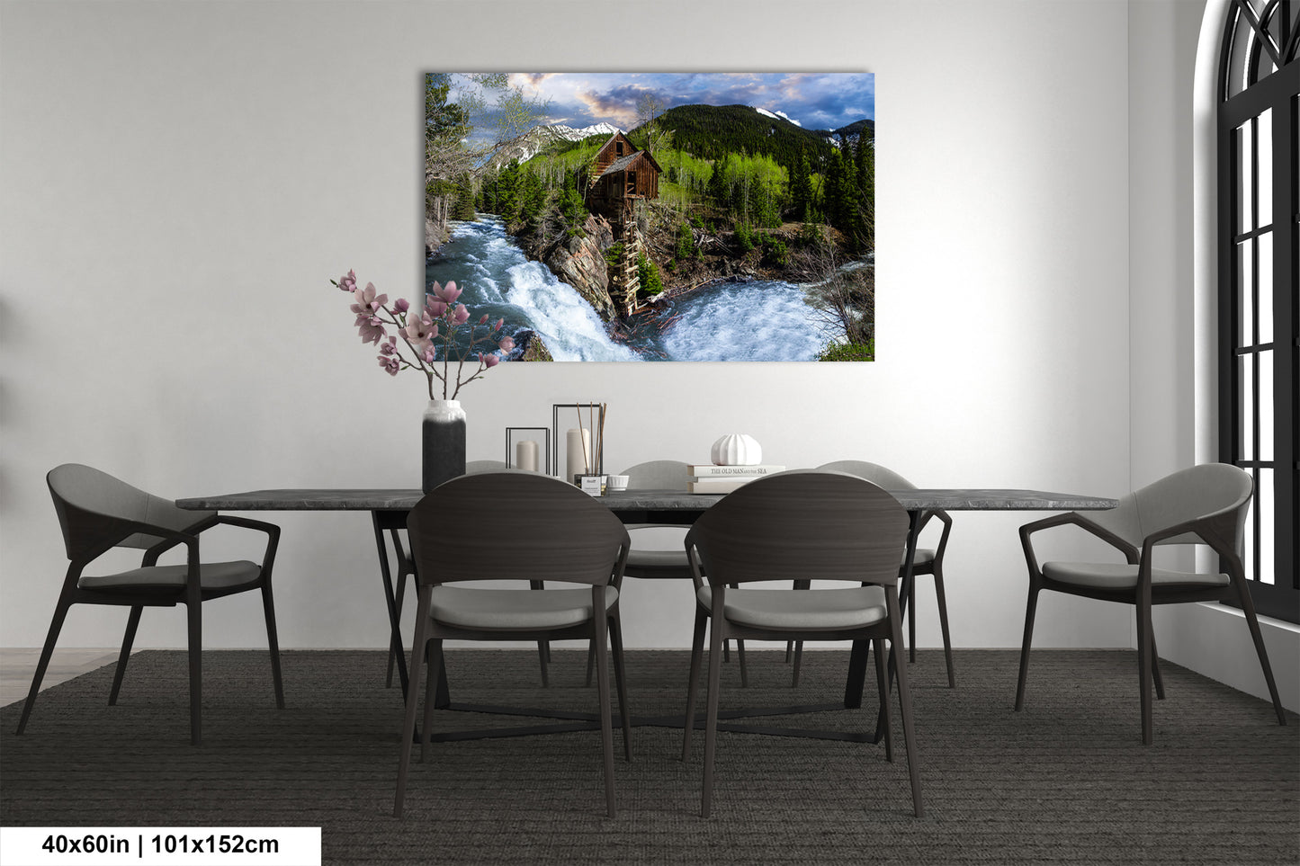 a dining room table with chairs and a painting on the wall