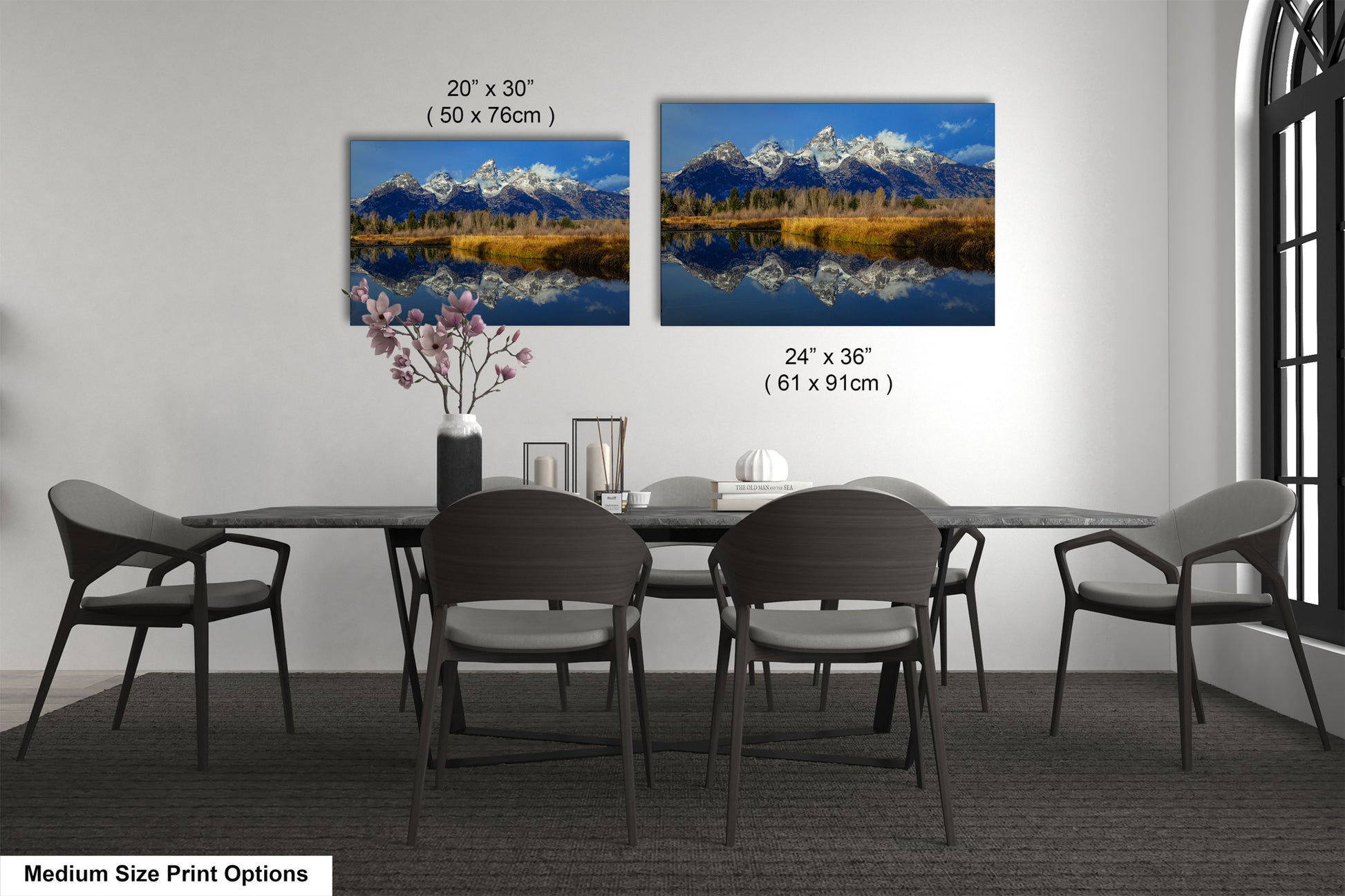 a dining table with four chairs and a vase with flowers