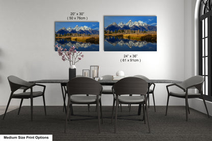 a dining table with four chairs and a vase with flowers