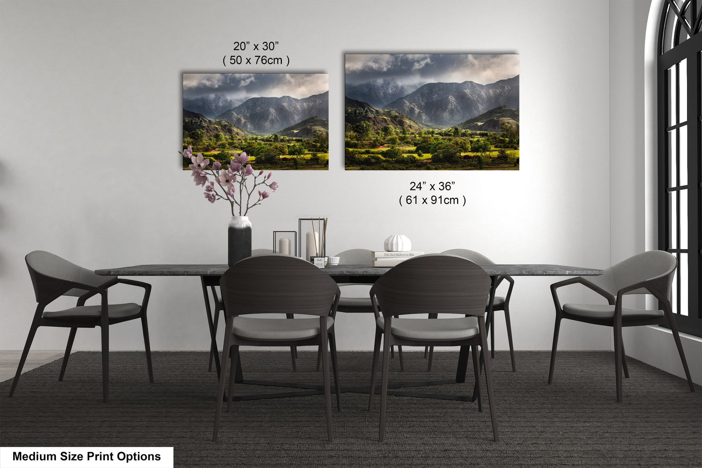 a dining table with four chairs and a vase of flowers