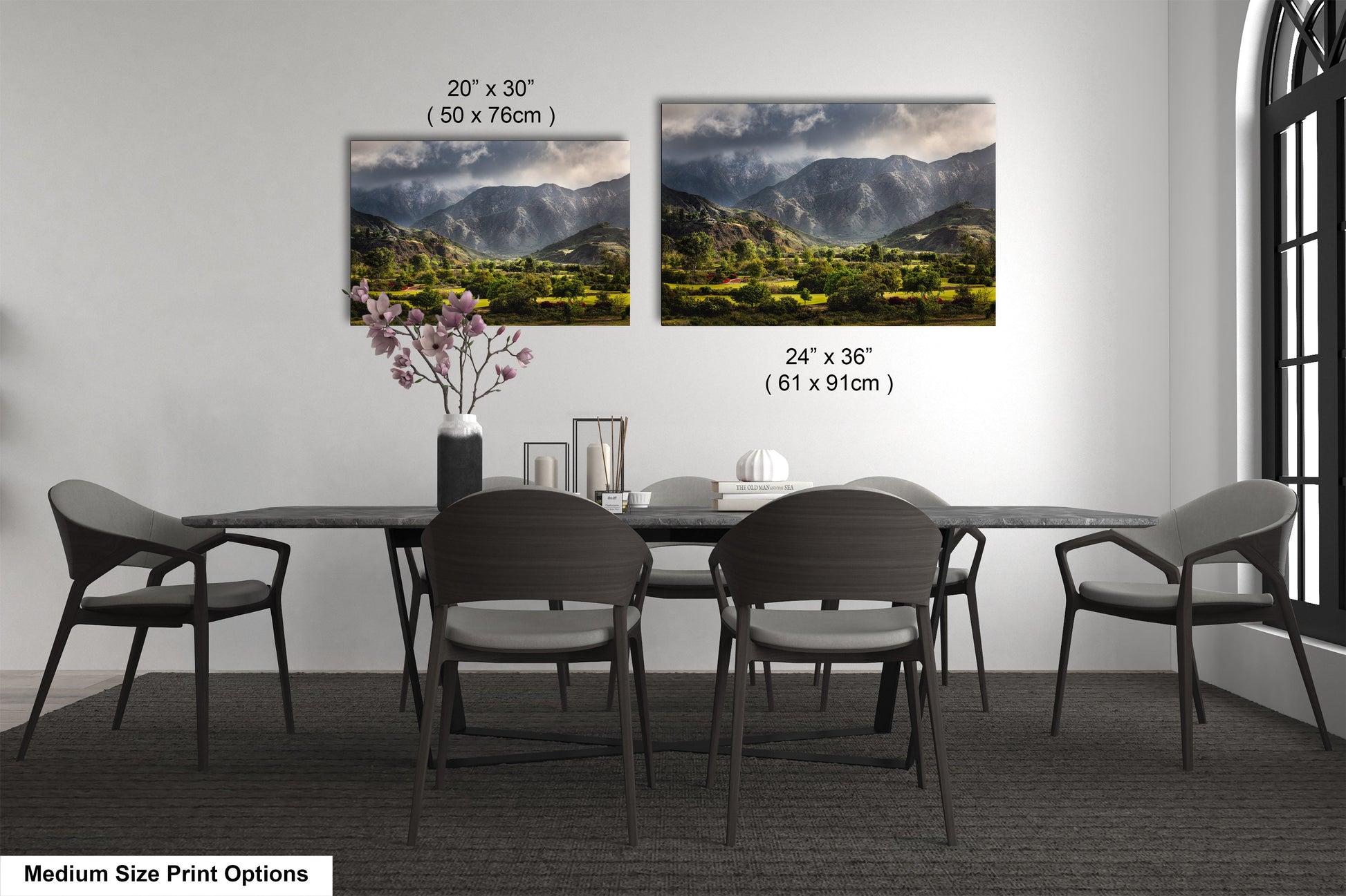 a dining table with four chairs and a vase of flowers