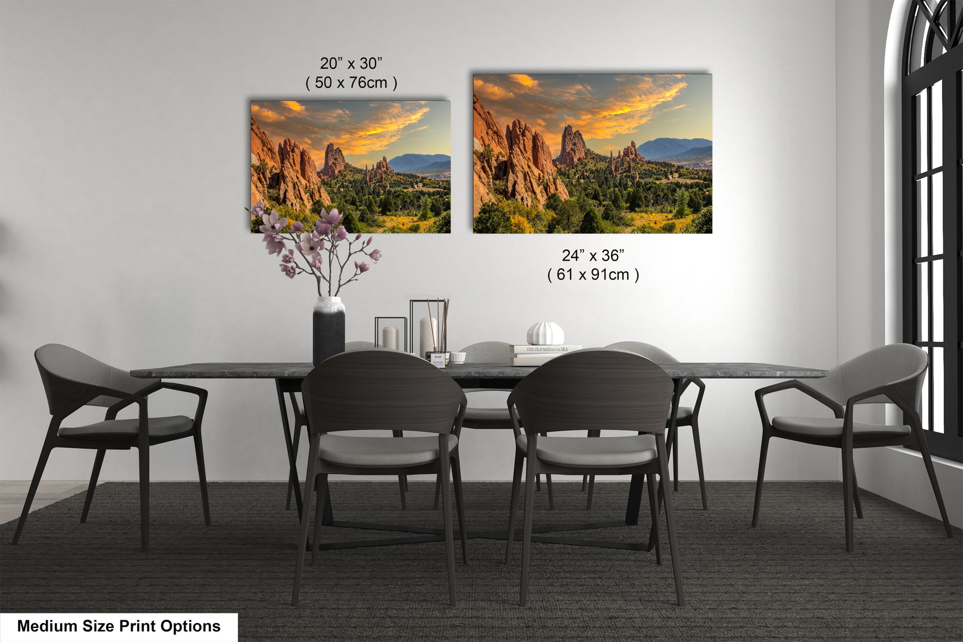 a dining room table with four chairs and a vase of flowers