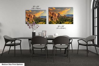 a dining room table with four chairs and a vase of flowers