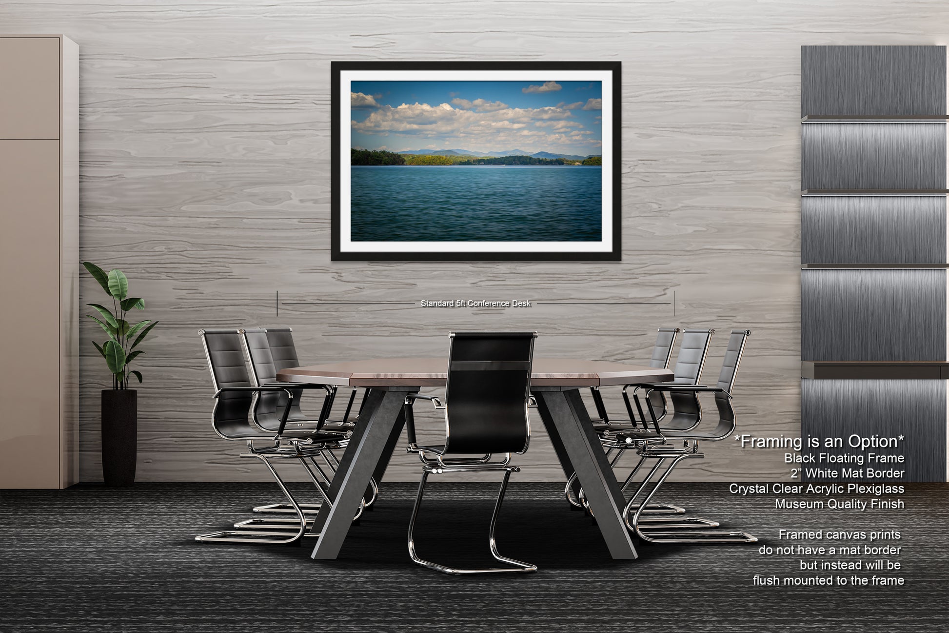 a modern office space with a large framed landscape photograph hanging on the wall above a wooden conference table surrounded by black chairs.