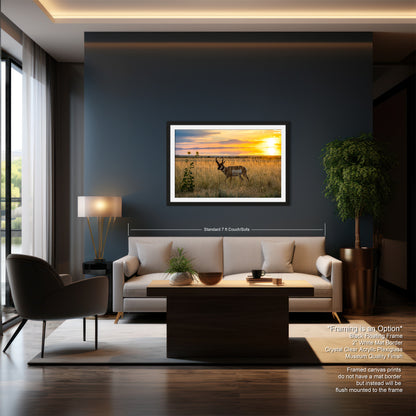 a modern living room with a large window, a gray sofa, a coffee table, and a framed picture of a deer in a field.