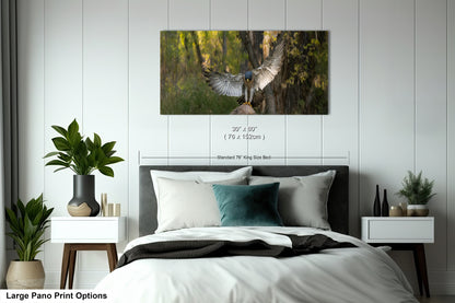 A large pano print depicting a bird in flight with its wings spread wide, set against a lush green forest backdrop.