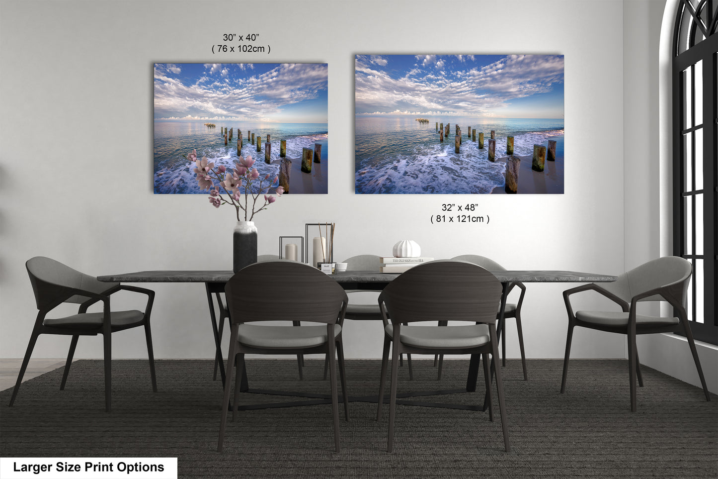 a dining room table with four chairs and a vase of flowers
