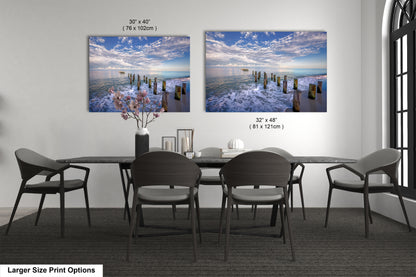 a dining room table with four chairs and a vase of flowers