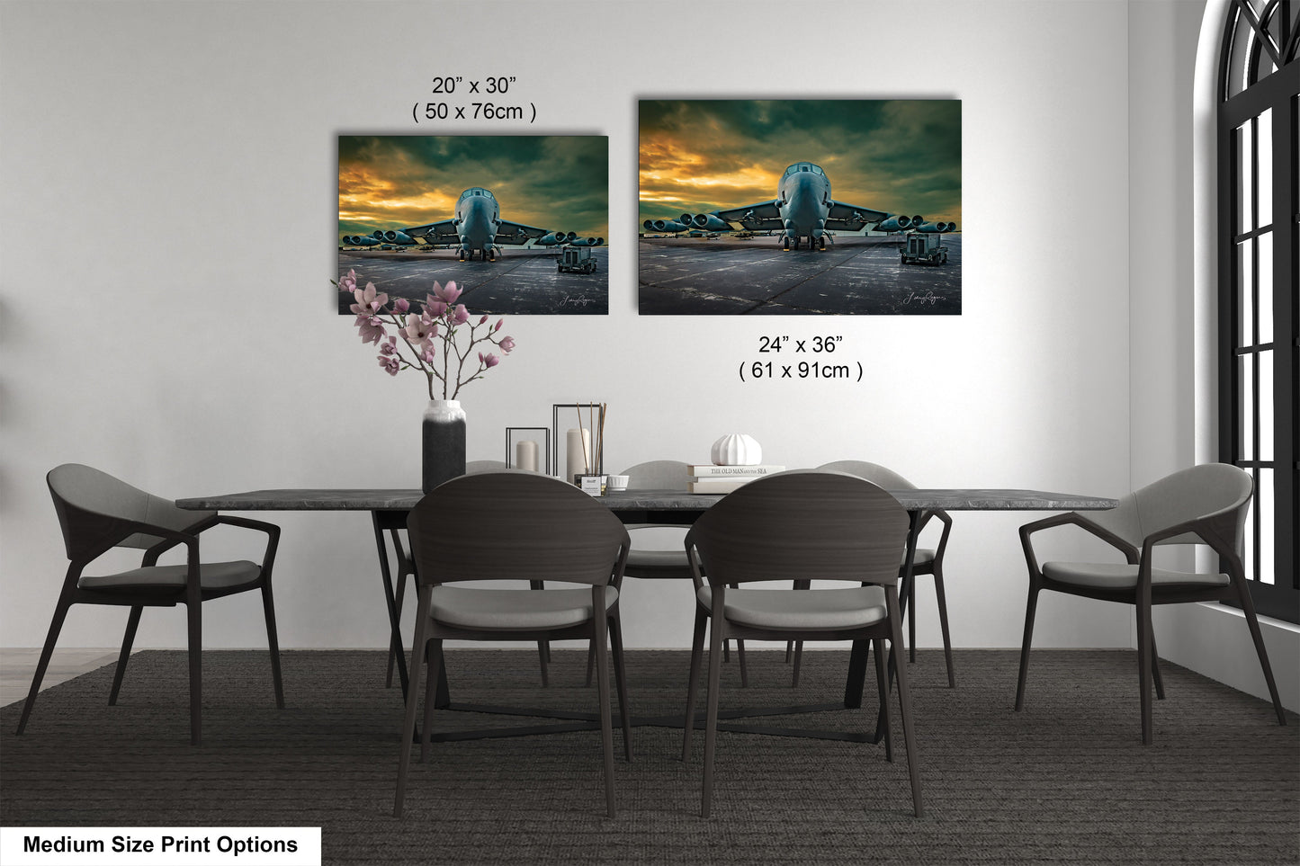 a dining table with four chairs and a vase of flowers