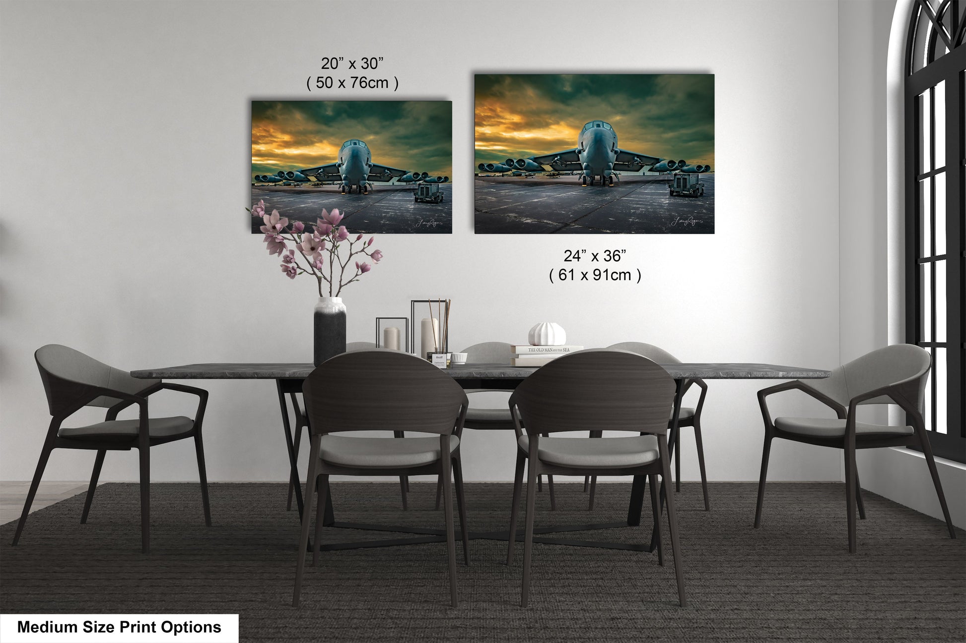 a dining table with four chairs and a vase of flowers