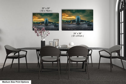 a dining table with four chairs and a vase of flowers