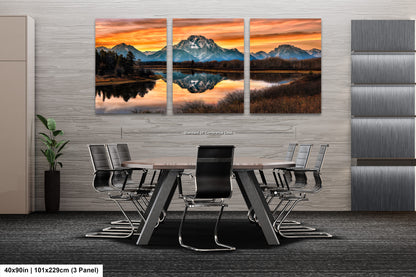 a dining room table with chairs and a painting on the wall