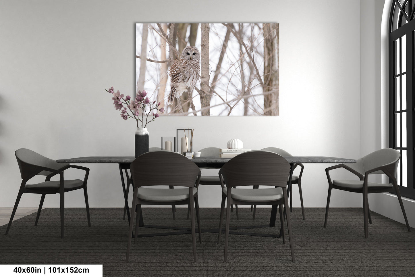 a dining room table with chairs and a vase of flowers