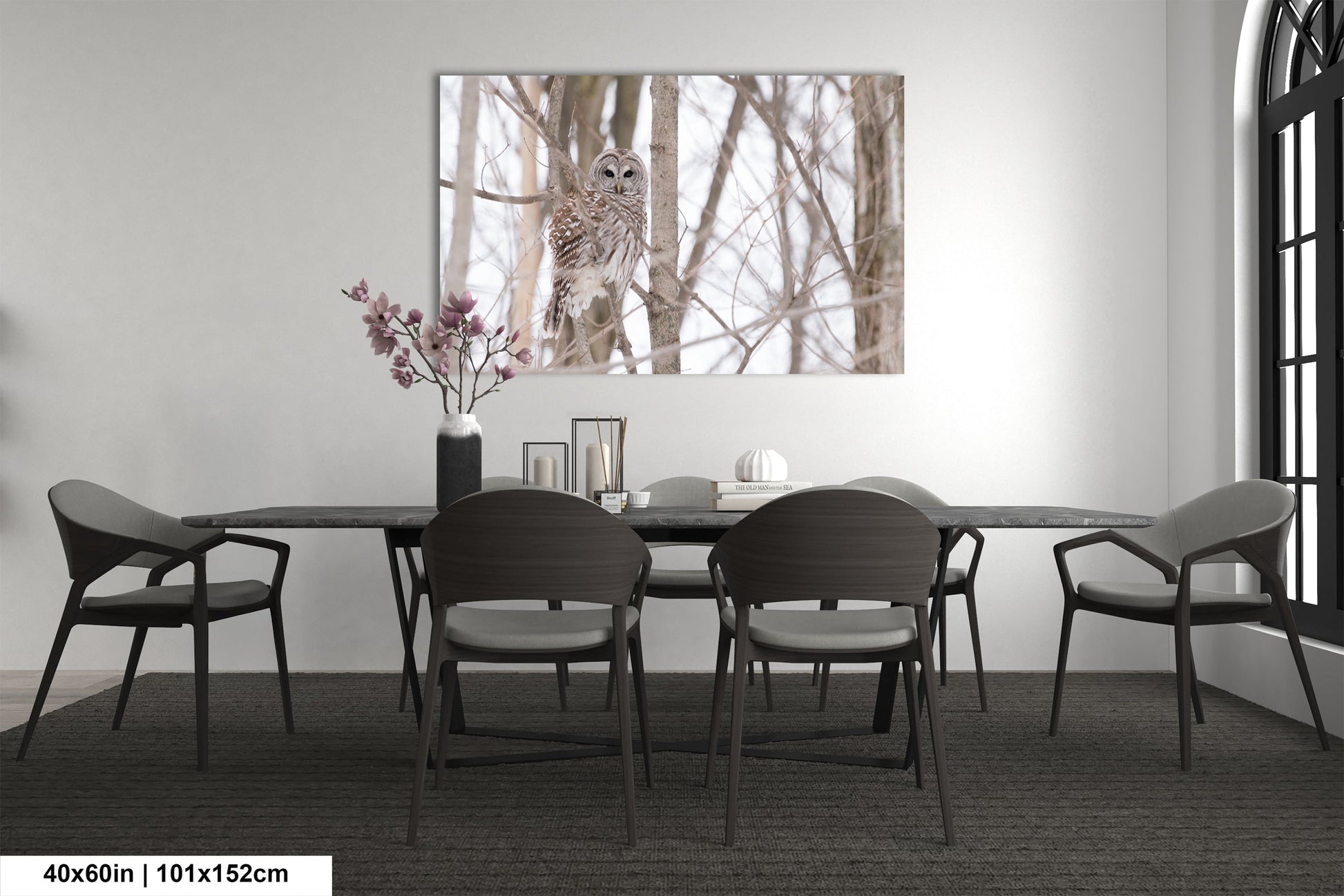 a dining room table with chairs and a vase of flowers