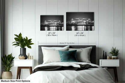 a bedroom with a bed and two pictures on the wall