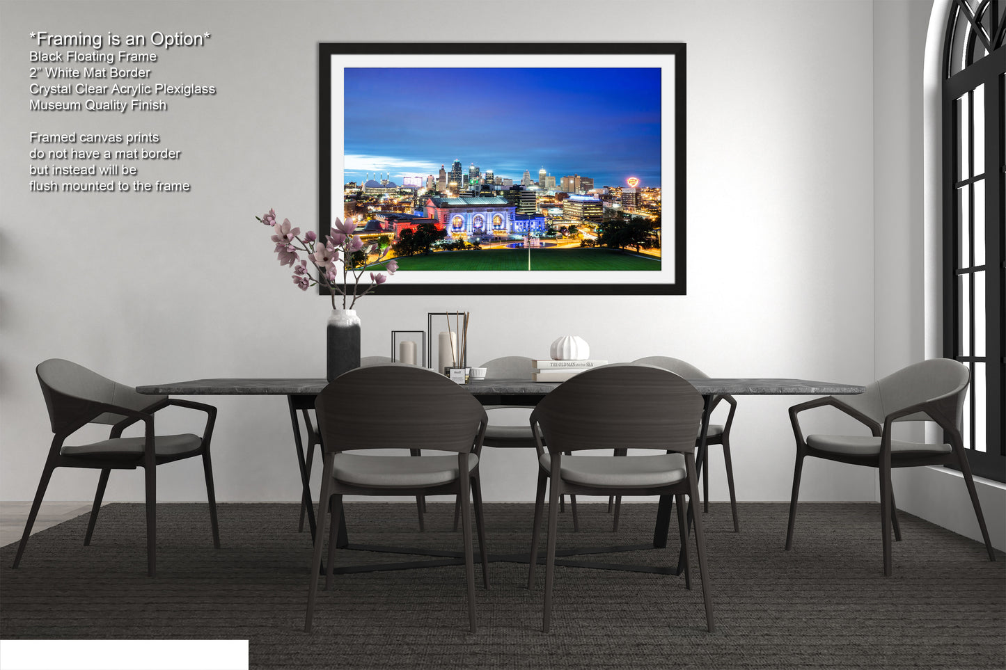 a dining room with a picture hanging on the wall