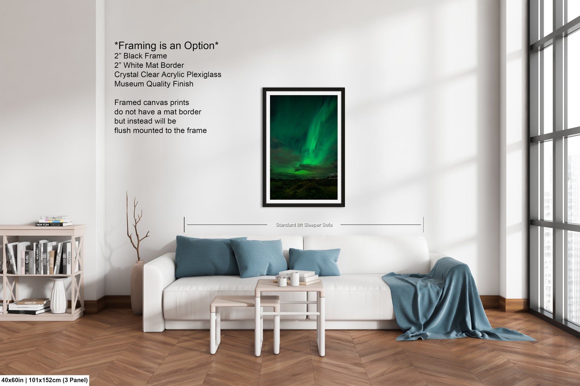 The image is a living room with a white sofa, a coffee table, and a bookshelf. Above the sofa, there is a framed picture of the Northern Lights, which is a natural phenomenon that occurs in the polar regions. The room has a modern and minimalist design, with a large window providing natural light.