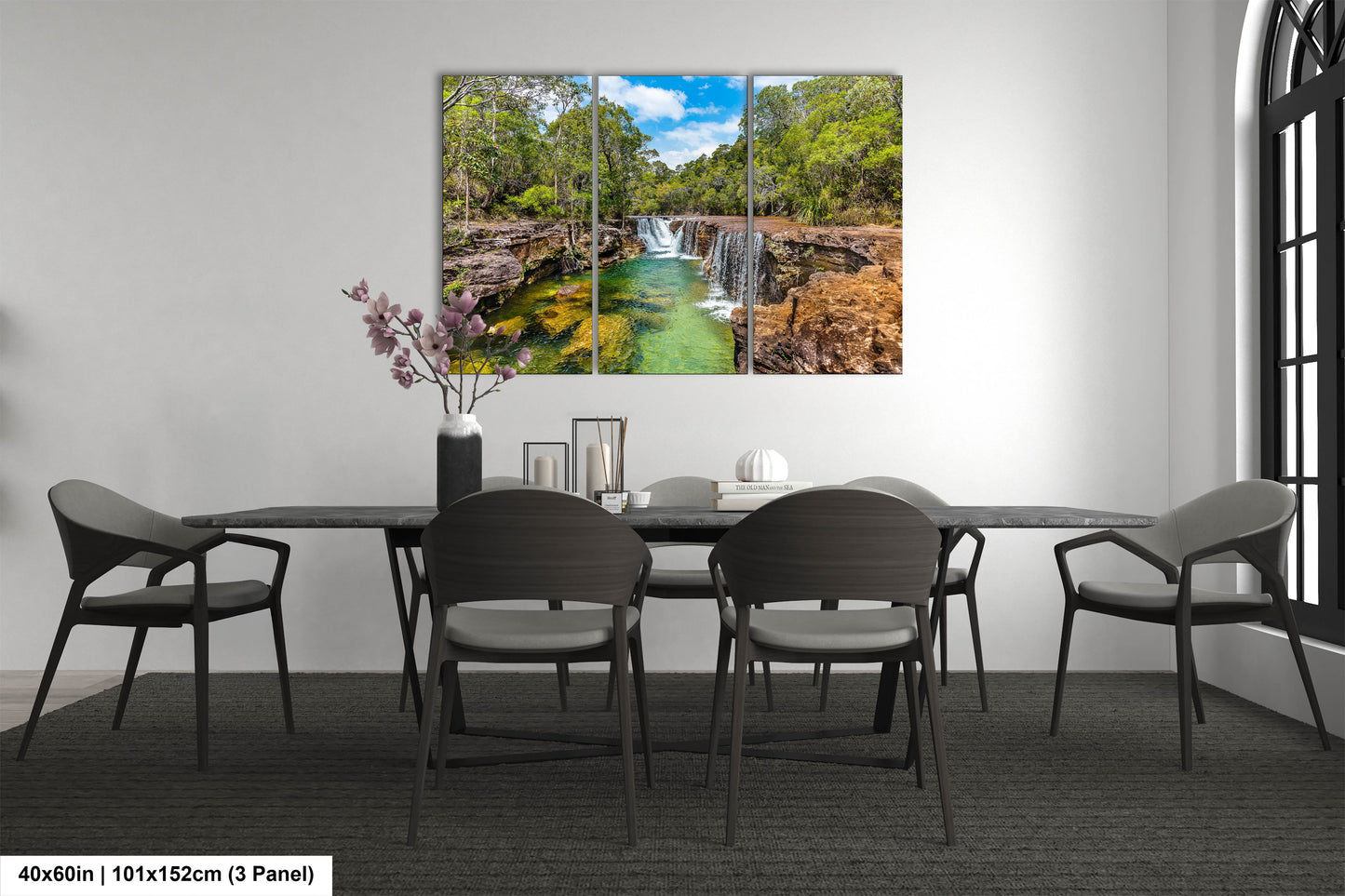 a dining room table with chairs and a painting on the wall