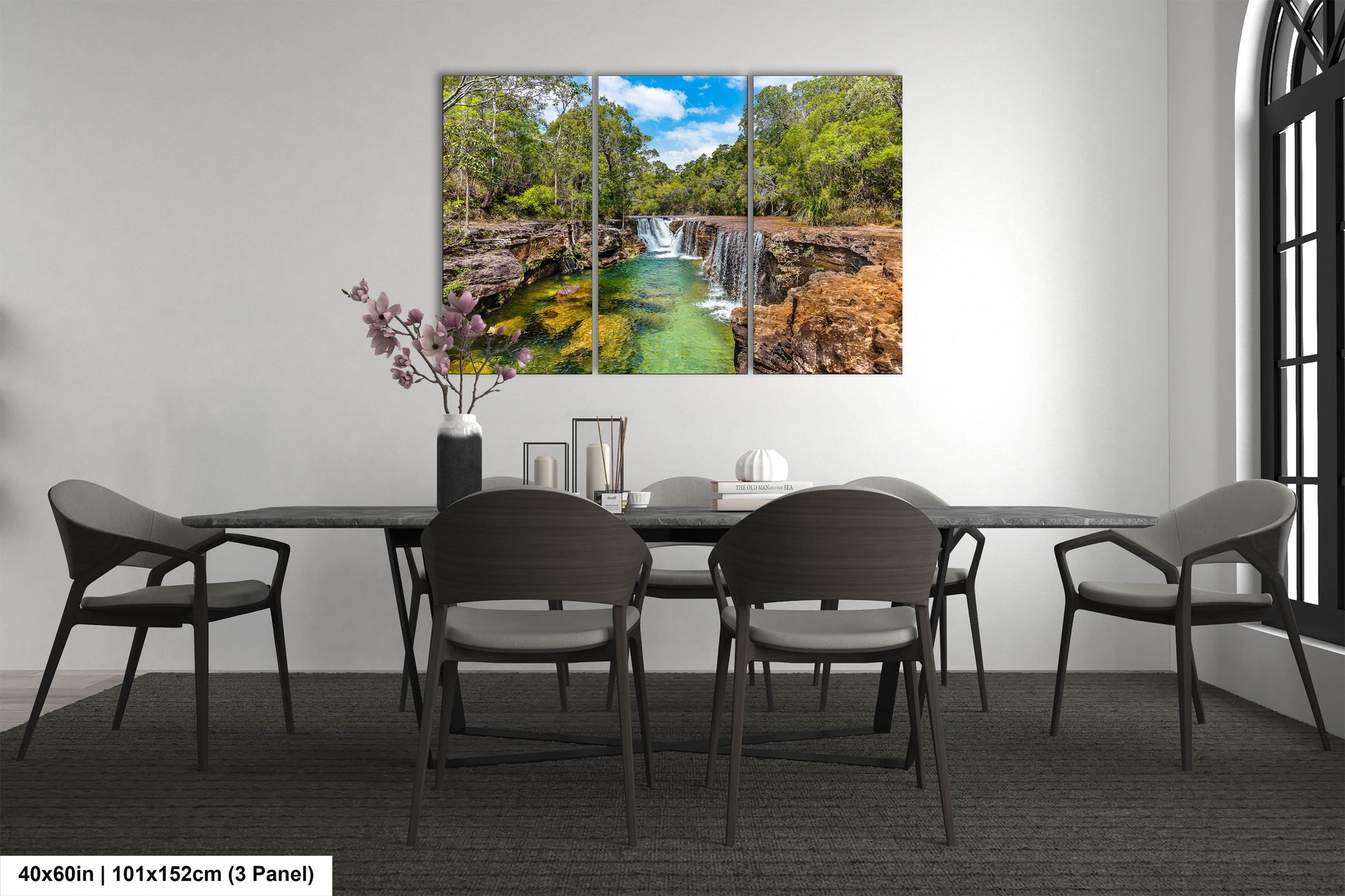 a dining room table with chairs and a painting on the wall