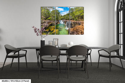 a dining room table with chairs and a painting on the wall