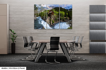 a dining room table with chairs and a painting on the wall
