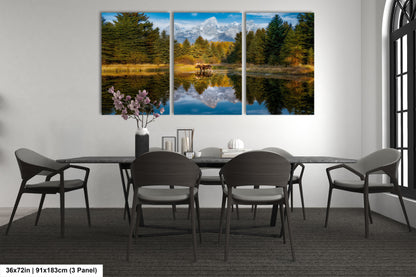 a dining room table with four chairs and a painting on the wall