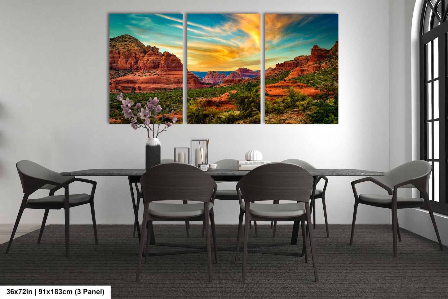 a dining room table with chairs and a painting on the wall
