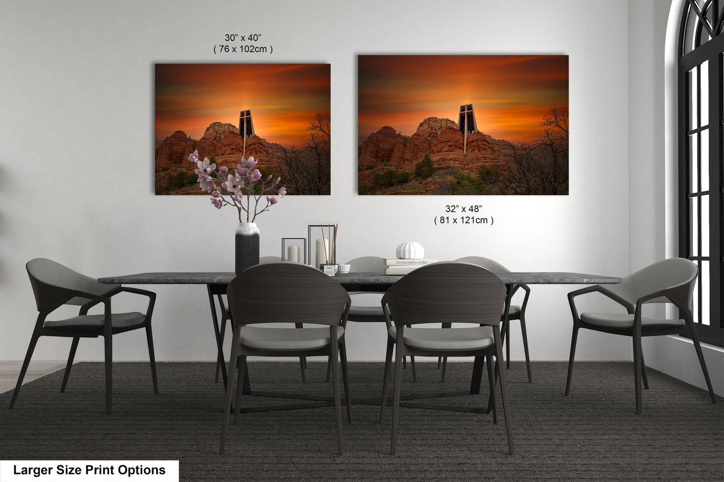 a dining table with four chairs and a vase of flowers