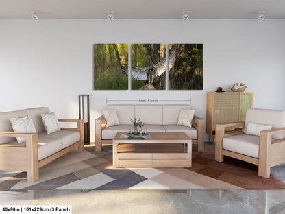 The image is a modern living room with a large, three-panel artwork depicting a bird in flight. The furniture includes a sofa, two armchairs, and a coffee table. The room has a minimalist and clean design, with white walls and a neutral color palette.