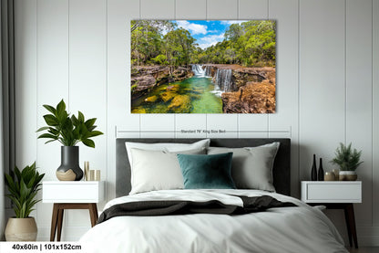 a bedroom with a bed and a painting on the wall