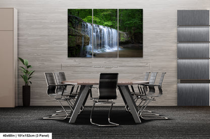 a dining room table with a waterfall in the background