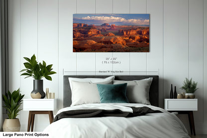 a bedroom with a large bed and a painting on the wall
