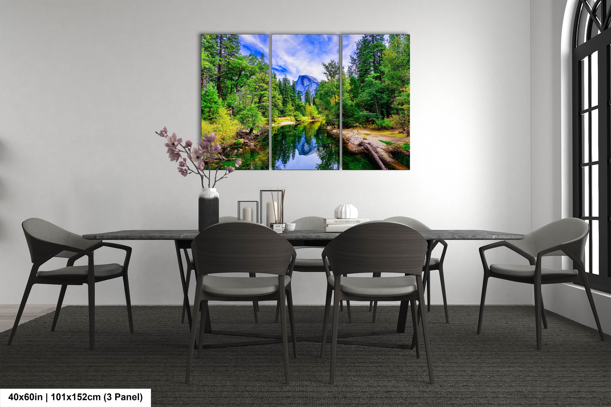 a dining room table with chairs and a painting on the wall
