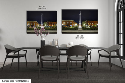 a dining room table with chairs and a vase of flowers