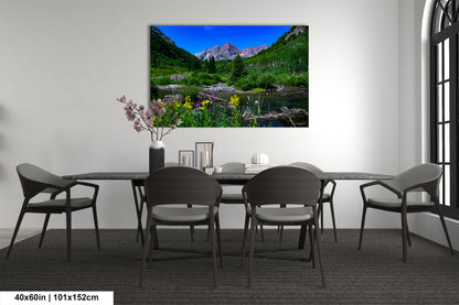 a room with a table and chairs and a painting on the wall
