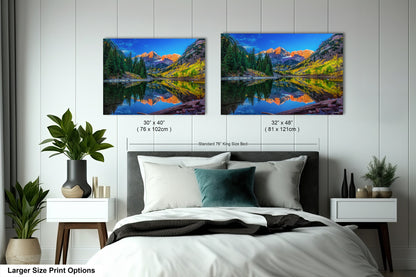 a bedroom with a bed and two pictures on the wall