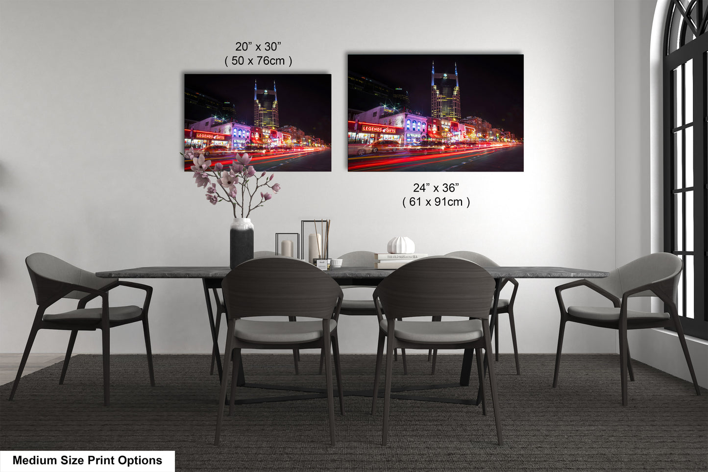 a dining room table with four chairs and a vase of flowers