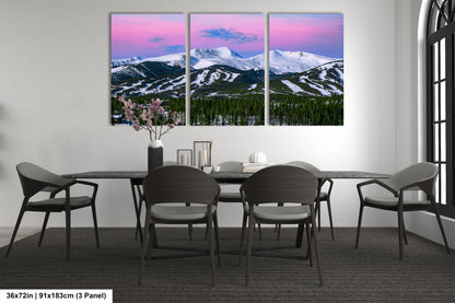 a dining room table with four chairs and a vase of flowers