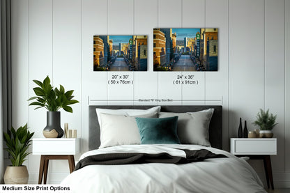 a bed room with a neatly made bed and two pictures on the wall
