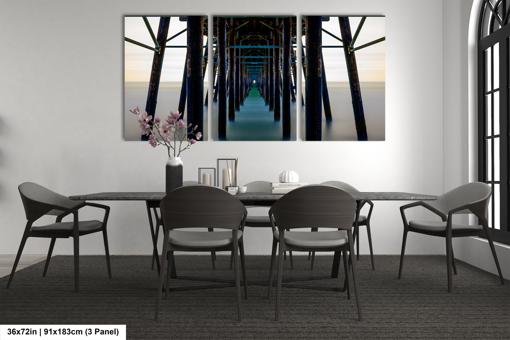 a dining room table with chairs and a painting on the wall