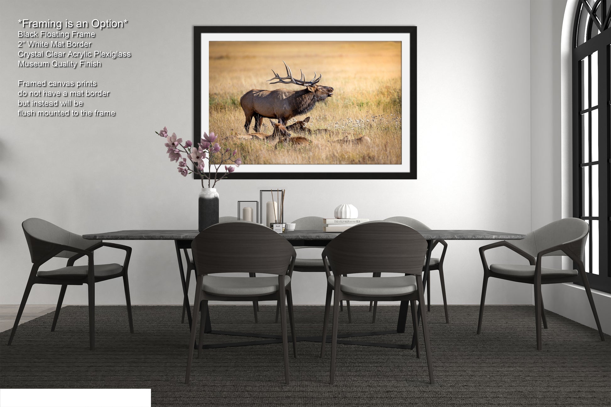 a dining room table with chairs and a picture of an elk