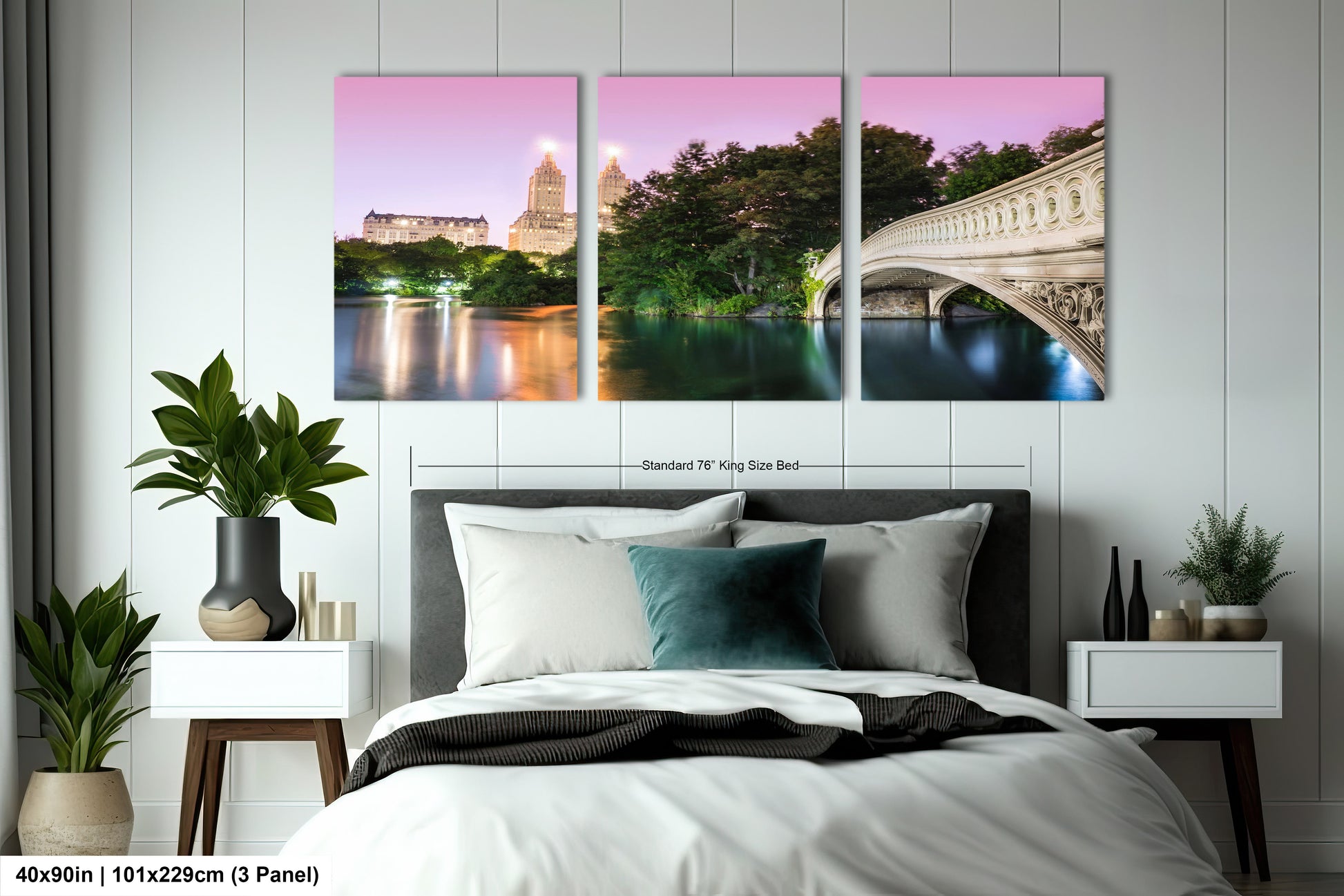 a bed with a white comforter and three paintings on the wall