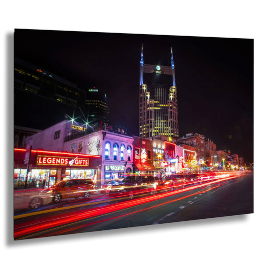 a city street at night with lights and buildings