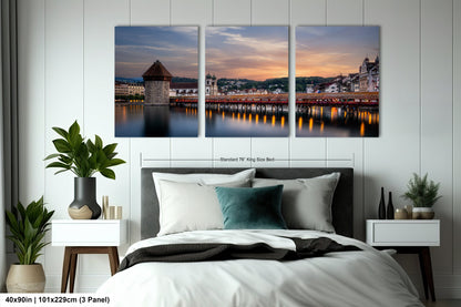 a bedroom with a large bed and three paintings on the wall