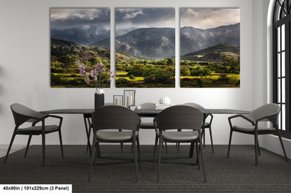 a dining room table with four chairs and a painting on the wall