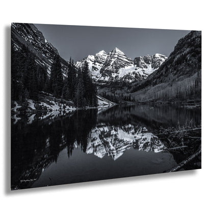 a black and white photo of a mountain lake